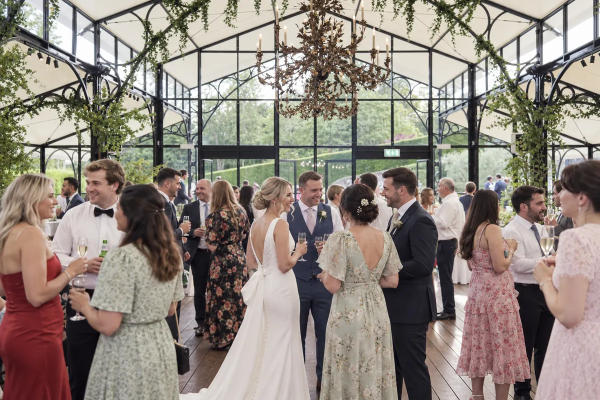 Wedding Drinks Reception Background Music at Port Lympne Bride and groom mingling with guests during their drinks reception at Port Lympne, Kent